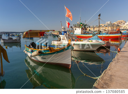 Traditional luzzu fishing boats in Marsaxlokk harbor Malta 137080585