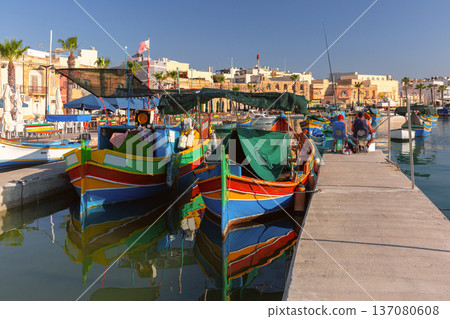 Traditional luzzu fishing boats in Marsaxlokk harbor Malta 137080608