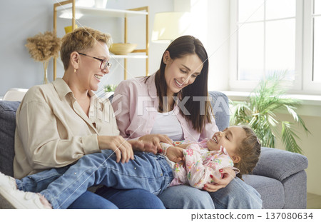 Happy Grandmother And Daughter Tickling At Home Happy Grandmother And Daughter Tickling At Home 137080634