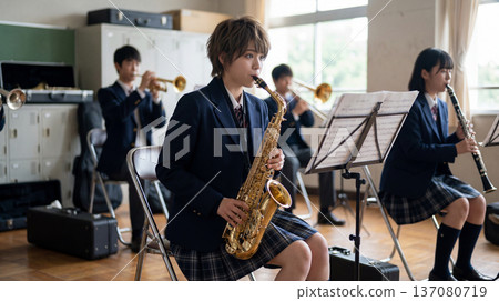 Female brass band member practicing the saxophone 137080719