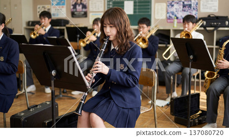 Female brass band member practicing clarinet 137080720