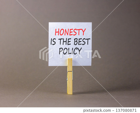 Honesty is the best policy symbol. Concept words Honesty is the best policy on beautiful white paper on clothespins. Beautiful grey background. Business honesty is the best policy concept Copy space Honesty is the best policy symbol. Concept words Honesty is the best policy on beautiful white paper on clothespins. Beautiful grey background. Business honesty is the best policy concept Copy space 137080871