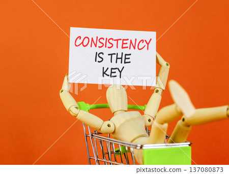 Consistency is the key symbol. Concept words Consistency is the key on beautiful white paper. Beautiful orange background. Businessman's model. Business consistency is the key concept. Copy space. 137080873