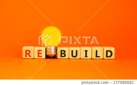 Rebuild and build symbol. The concept word Rebuild on wooden cubes. Beautiful orange background. Beautiful yellow light bulb. Copy space. Business rebuild and build concept. Rebuild and build symbol. The concept word Rebuild on wooden cubes. Beautiful orange background. Beautiful yellow light bulb. Copy space. Business rebuild and build concept. 137080882