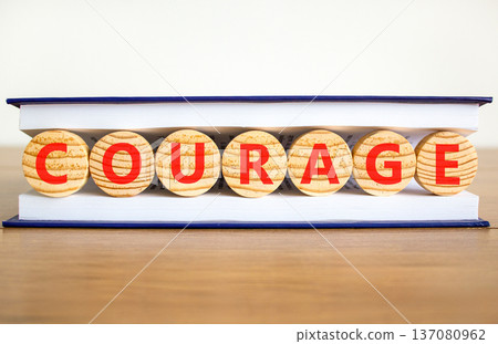 Courage symbol. Concept word Courage on beautiful wooden circles in book. Beautiful wooden table white background. Business courage concept. Copy space. Courage symbol. Concept word Courage on beautiful wooden circles in book. Beautiful wooden table white background. Business courage concept. Copy space. 137080962