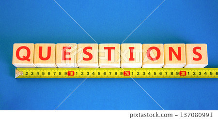 Question questions symbol. Concept word Questions on beautiful wooden blocks. Beautiful blue background. Beautiful yellow ruler. Business education support questions concept. Copy space. Question questions symbol. Concept word Questions on beautiful wooden blocks. Beautiful blue background. Beautiful yellow ruler. Business education support questions concept. Copy space. 137080991