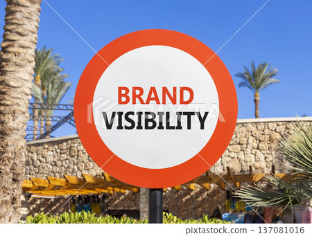 Brand visibility symbol. Concept words Brand visibility on beautiful white road sign. Beautiful blue sky palm trees background. Business branding and brand visibility concept. Copy space. 137081016