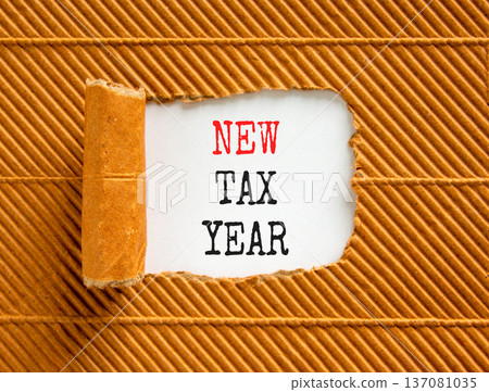 New tax year symbol. Concept words New tax year on beautiful white paper. Beautiful brown table brown background. Business new tax year concept. Copy space. 137081035