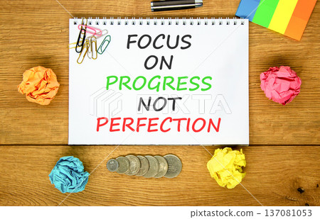Progress or perfection words symbol. Concept words Focus on progress not perfection on beautiful white note. Beautiful wooden background. Business progress or perfection concept. Copy space. Progress or perfection words symbol. Concept words Focus on progress not perfection on beautiful white note. Beautiful wooden background. Business progress or perfection concept. Copy space. 137081053