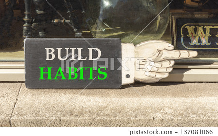 Build habits symbol. Concept word Build habits on beautiful black wooden hand with finger. Beautiful shop display background. Business build habits concept. Copy space. Build habits symbol. Concept word Build habits on beautiful black wooden hand with finger. Beautiful shop display background. Business build habits concept. Copy space. 137081066