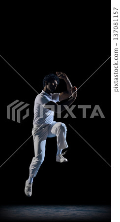 Cricket bowler in mid air delivery on black stage wearing white sports outfit. Cricket bowler in mid air delivery on black stage wearing white sports outfit. 137081157