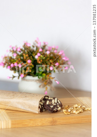 Chocolate salami sausage on wooden board Chocolate salami sausage on wooden board 137081235