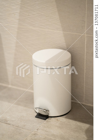 White pedal bin providing a practical solution for waste disposal in a clean, modern bathroom setting, emphasizing hygiene and tidiness in a home environment White pedal bin providing a practical solution for waste disposal in a clean, modern bathroom setting, emphasizing hygiene and tidiness in a home environment 137081711
