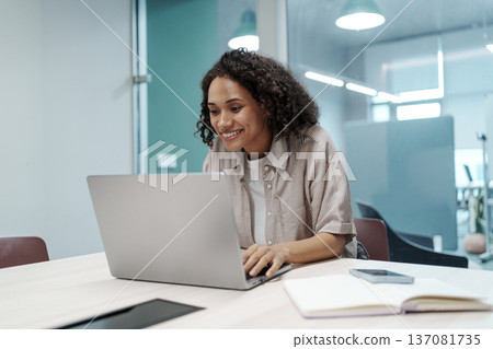 Woman Editing Content On Computer. Female Professional Focusing On Laptop Editing With Accessories Nearby Woman Editing Content On Computer. Female Professional Focusing On Laptop Editing With Accessories Nearby 137081735
