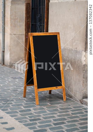 Blank chalkboard sandwich board offering outdoor advertising space Blank chalkboard sandwich board offering outdoor advertising space 137082342