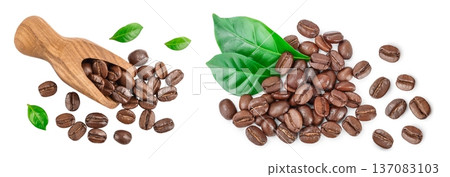 Heap of roasted coffee beans in wooden scoop with leaves isolated on white background. Top view. Flat lay. Heap of roasted coffee beans in wooden scoop with leaves isolated on white background. Top view. Flat lay. 137083103
