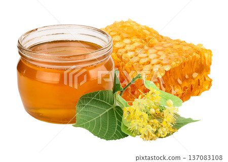 honeycomb with honey and linden flowers isolated on white background. honeycomb with honey and linden flowers isolated on white background. 137083108