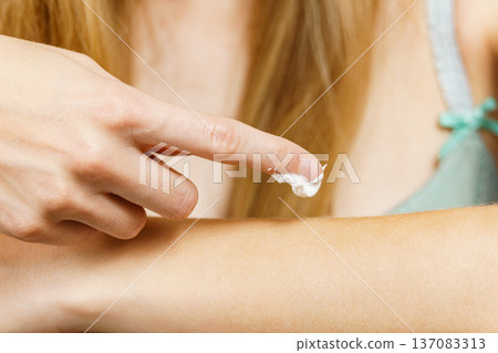 Woman apply moisturizer cream on her body Woman apply moisturizer cream on her body 137083313