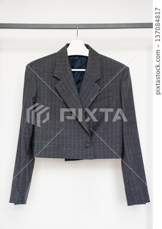 Cropped wool pinstripe blazer on hanger isolated on white background for fashion retail  137084817