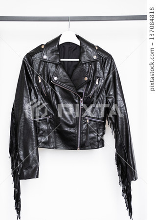 Black faux leather biker jacket with silver zippers and long fringe detail on sleeves for retail use Black faux leather biker jacket with silver zippers and long fringe detail on sleeves for retail use 137084818