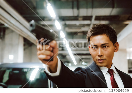 Holding a gun in a parking lot 137084969