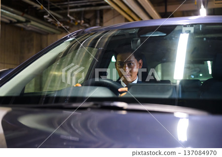 Man looking out from inside the car Man looking out from inside the car 137084970