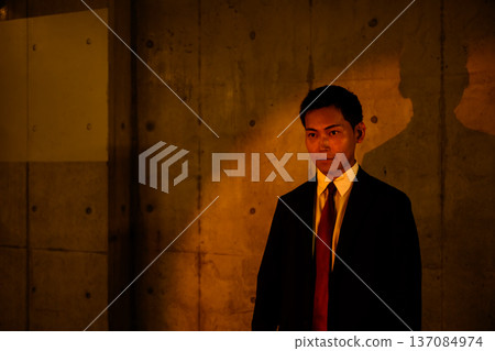 Man in suit in the dark Man in suit in the dark 137084974
