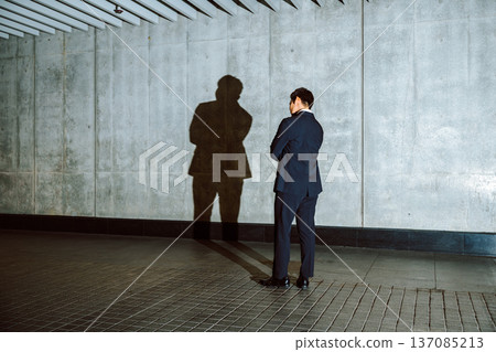 Confronting a shadow in a suit 137085213