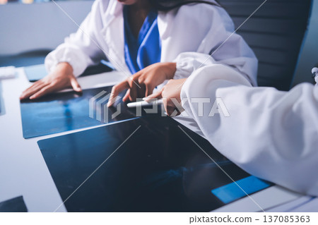Medical Team Meeting, Doctors Taking Notes During Briefing Session Medical Team Meeting, Doctors Taking Notes During Briefing Session 137085363
