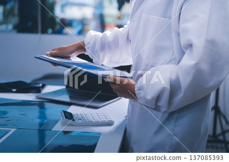 Medical Team Meeting, Doctors Taking Notes During Briefing Session Medical Team Meeting, Doctors Taking Notes During Briefing Session 137085393