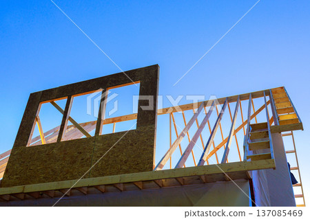 Workers build structure with wooden frames stairs under build wood beam roof trusses structures 137085469