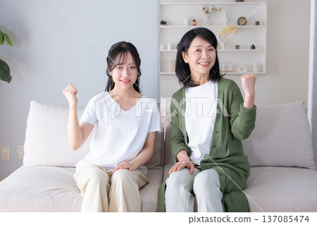 Mother and daughter playing guts pose Mother and daughter playing guts pose 137085474