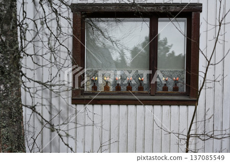 A quiet exterior view of a traditional wooden house window in a rural Nordic setting A quiet exterior view of a traditional wooden house window in a rural Nordic setting 137085549