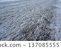 a frozen ice surface covered with numerous skate marks and scratches 137085555