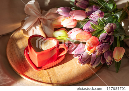 Heart Shaped Coffee Cup with Tulips on Bed. Romantic Valentines Day Celebration 137085701