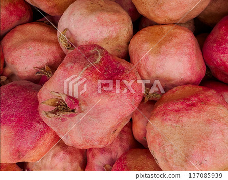 Ripe bunch of red pomegranates are piled on top of each other. Ripe bunch of red pomegranates are piled on top of each other. 137085939