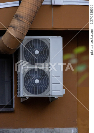 air conditioning on facade of building, air cooling in hot weather. air conditioning on facade of building, air cooling in hot weather. 137086093