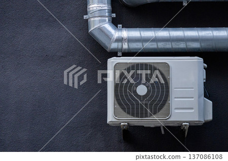 air conditioning on facade of building, air cooling in hot weather. air conditioning on facade of building, air cooling in hot weather. 137086108