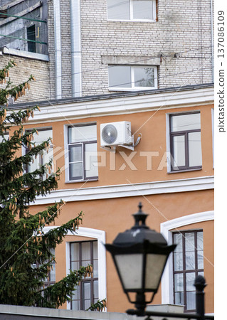 air conditioning on facade of building, air cooling in hot weather. air conditioning on facade of building, air cooling in hot weather. 137086109