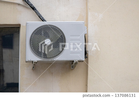air conditioning on facade of building, air cooling in hot weather. air conditioning on facade of building, air cooling in hot weather. 137086131