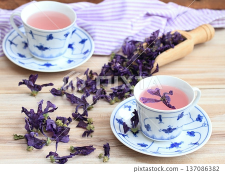 Two cups of herbal tea from dried flowers of Wild mallow, lat. Malva sylvestris. Two cups of herbal tea from dried flowers of Wild mallow, lat. Malva sylvestris. 137086382