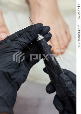 Pedicure with electric nail drill Pedicure with electric nail drill 137086617