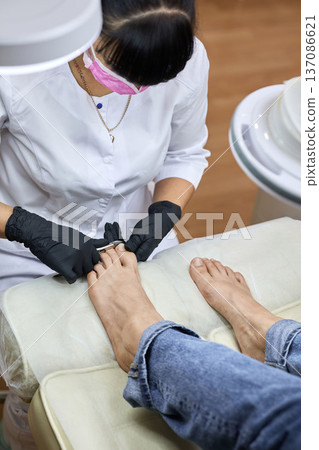 Professional pedicure procedure in beauty salon 137086621