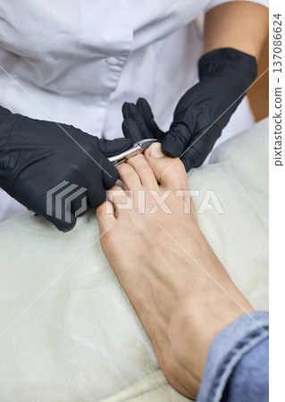 Pedicure procedure with nail clipping in salon Pedicure procedure with nail clipping in salon 137086624