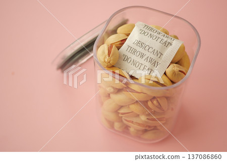Container holding pistachios with desiccant warning label Container holding pistachios with desiccant warning label 137086860