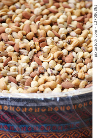 Nuts displayed in a traditional container at a market Nuts displayed in a traditional container at a market 137086863