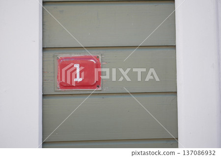 Door number one on a green wooden wall Door number one on a green wooden wall 137086932