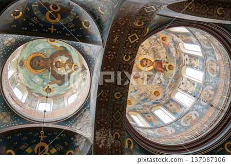 New Athos, Abkhazia - February 14, 2026: Interior ceiling of monastery cathedral with fresco painting, religious iconography and decorative vault architecture. Historic church art New Athos, Abkhazia - February 14, 2026: Interior ceiling of monastery cathedral with fresco painting, religious iconography and decorative vault architecture. Historic church art 137087306