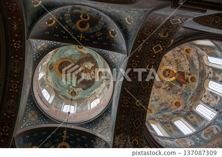 New Athos, Abkhazia - February 14, 2026: Interior ceiling of monastery cathedral with fresco painting, religious iconography and decorative vault architecture. Historic church art New Athos, Abkhazia - February 14, 2026: Interior ceiling of monastery cathedral with fresco painting, religious iconography and decorative vault architecture. Historic church art 137087309