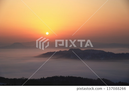 Sunrise from a hill overlooking a sea of clouds Sunrise from a hill overlooking a sea of clouds 137088266